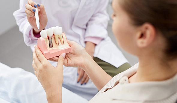 Dentist explaining how dental implants work in San Antonio
