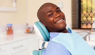 Man smiling after getting All-On-4/ Pro Arch dental implants in San Antonio