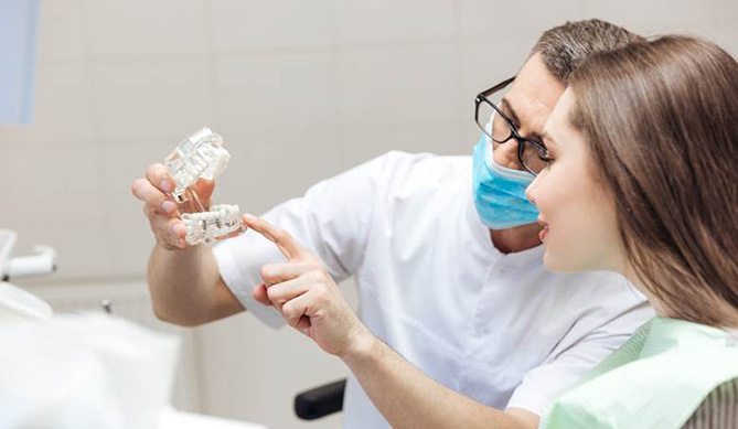 San Antonio implant dentist explaining dental implants to patient