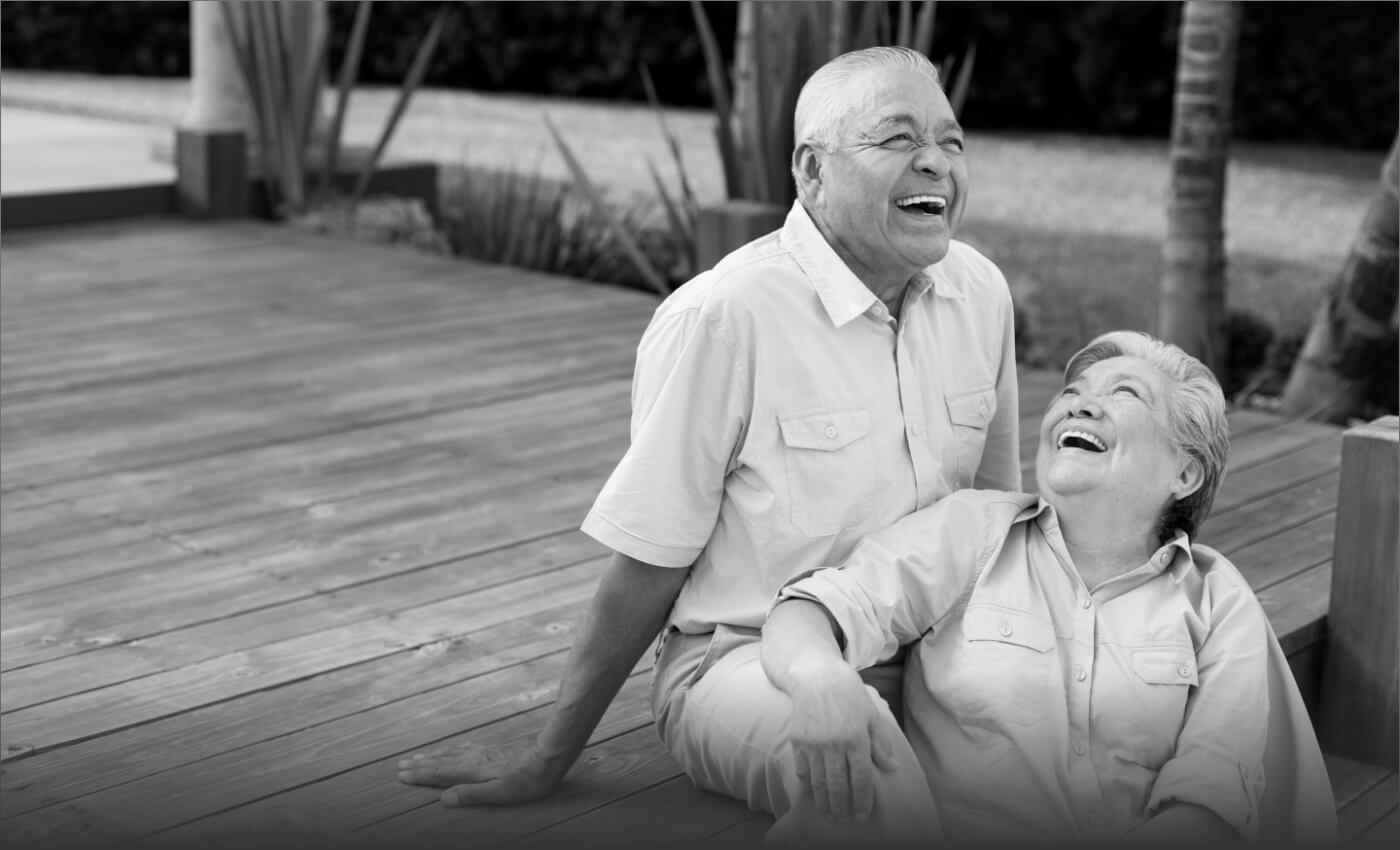 Older man and woman smiling after dental implant tooth replacement