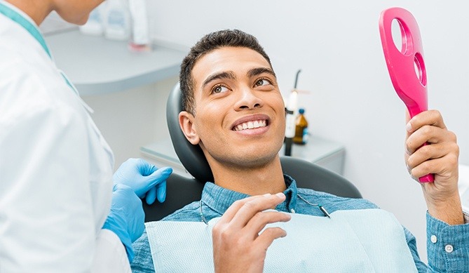 Dentist talking to patient about laser frenectomy treatment