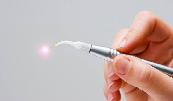 An up-close look at a person holding a soft tissue laser