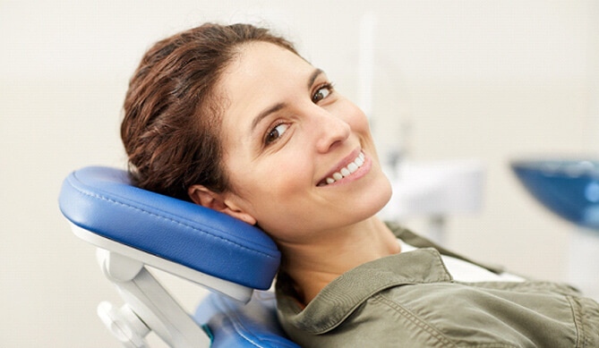 Female patient leaning back in chair and smiling