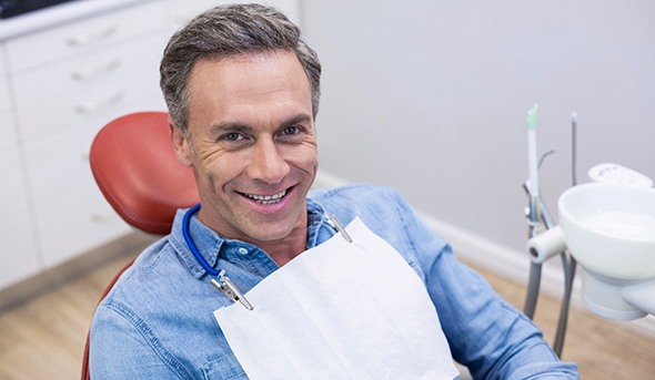 Man smiling and giving thumbs up after getting dental implants in San Antonio, TX