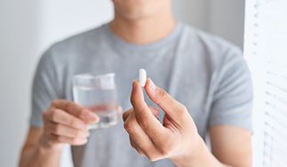 Man preparing to swallow sedative pill