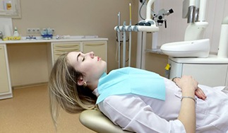 Reclining dental patient with closed eyes