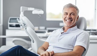 Smiling dental patient in treatment chair