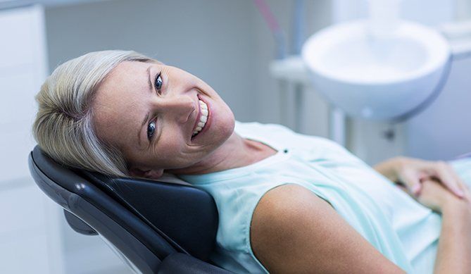 Relaxing woman in the dental chair for periodontal therapy