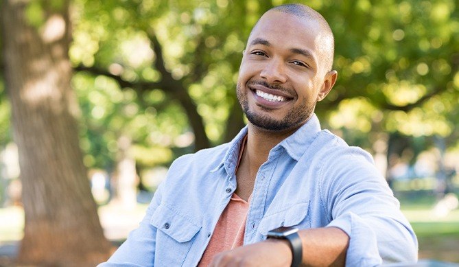 Man smiling after minimally invasive periodontal surgery