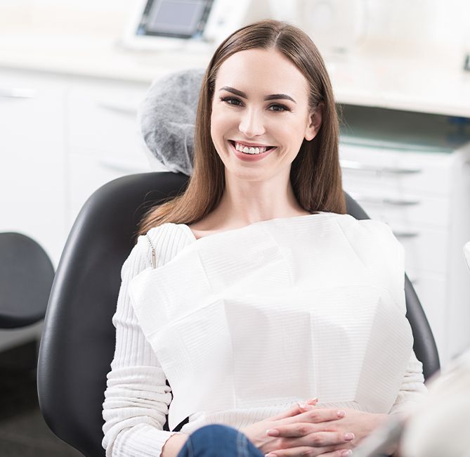 Woman in dental chair before perioscopy assisted scaling and root planing treatment