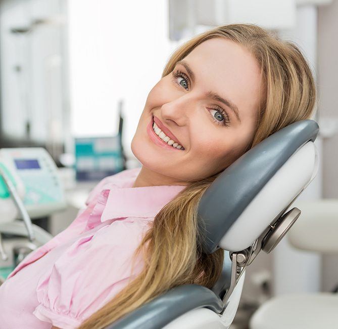 Woman in dental chair smiling