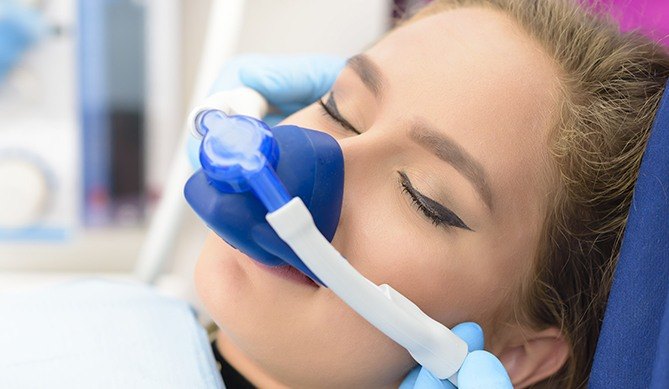 Woman with nitrous oxide sedation dentistry mask